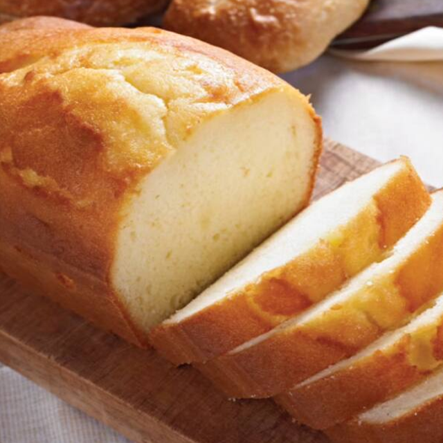 Loaf of bread sliced on a wooden cutting board